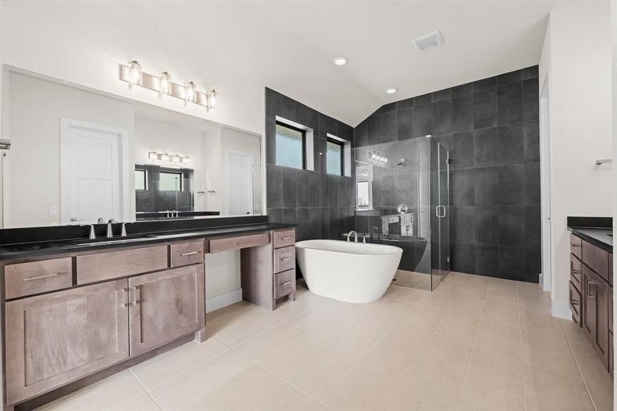 Primary Bathroom with Separate Vanities, Freestanding Tub, and Separate Frameless Shower Enclosure