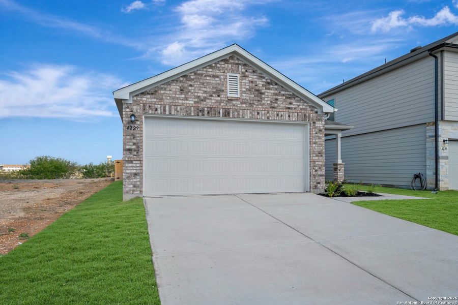 Front exterior of a new home in Park Place, New Braunfels, TX, highlighting curb appeal (Image 2). Front exterior of a new home in Park Place, New Braunfels, TX, highlighting curb appeal (Image 2).
