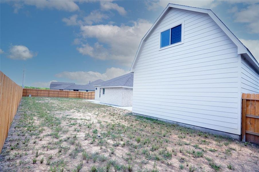 The large lot leaves an expanse of yard to the rear.