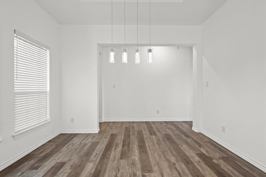 Empty room with dark hardwood / wood-style flooring