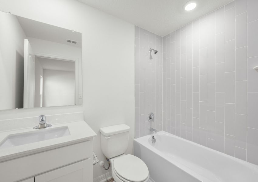This master bathroom has a beautifully tiled shower tub combo!