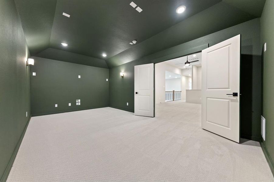 This spacious media room paired with adjacent game room create the ultimate entertainment zone!