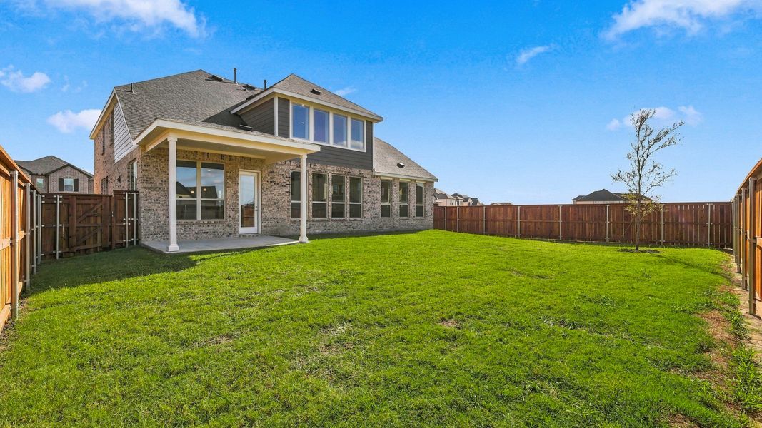 Exterior details and patio area of a home in Green Meadows Classic, Celina (Image 26).