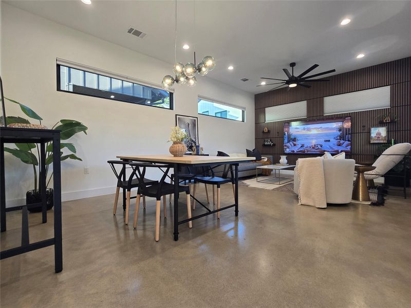 Polished concrete floors and high ceilings frame this versatile open-concept living space.