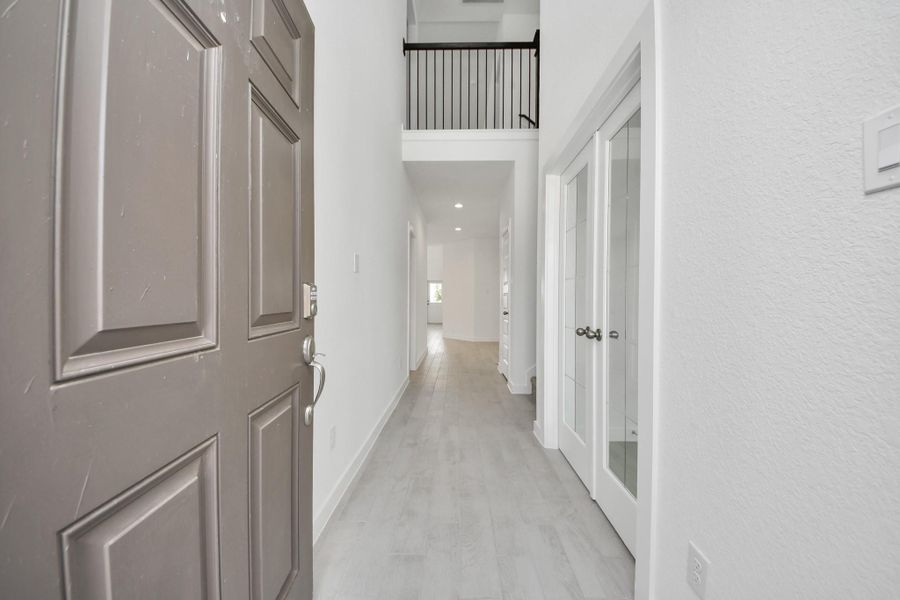 As you step into the threshold of this luxurious home, you'll soon be welcomed by an elegant glass door (to be installed). Inside, soaring ceilings amplify the spaciousness, while the refined wood-look tile flooring and oversized baseboards exude sophistication and charm.