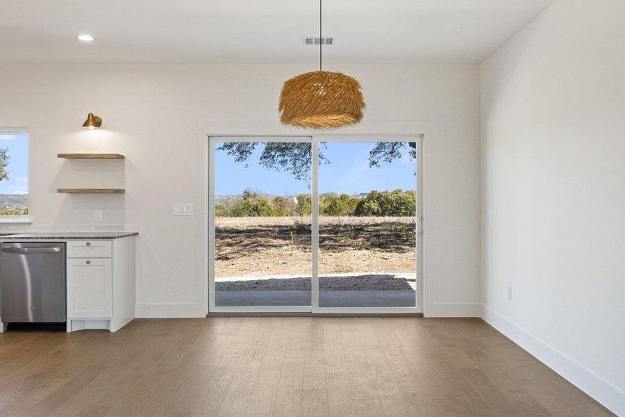 Unfurnished dining area featuring light wood-style flooring, healthy amount of natural light, and recessed lighting