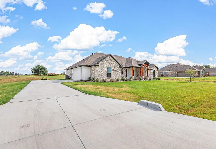 View of front of property with a garage and a front yard