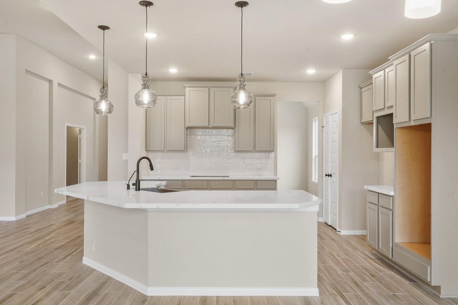 Gourmet kitchen with curved island (*Photo not of actual home and used for illustration purposes only.) Gourmet kitchen with curved island (*Photo not of actual home and used for illustration purposes only.)