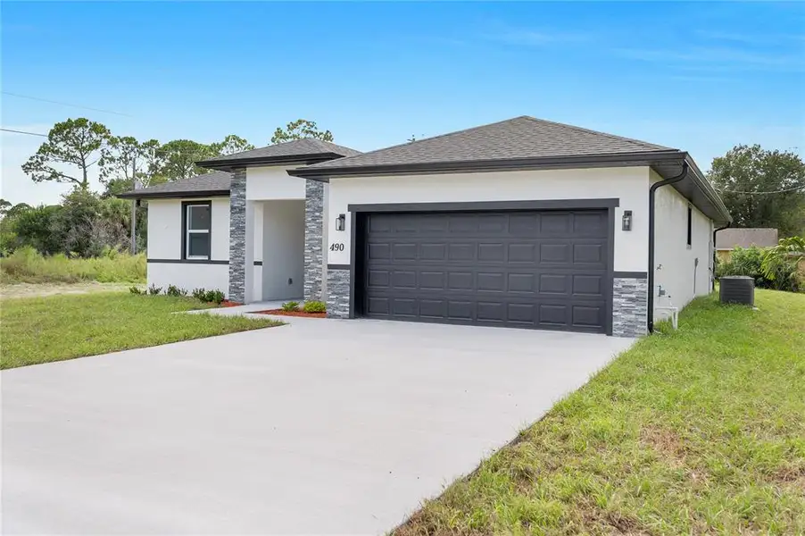 Front exterior of a new home in , Palm Bay, FL, highlighting curb appeal (Image 23).