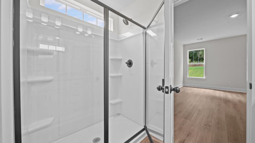 Exceptional en-suite with dual vanity and glass-enclosed walk-in shower for superior everyday comfort