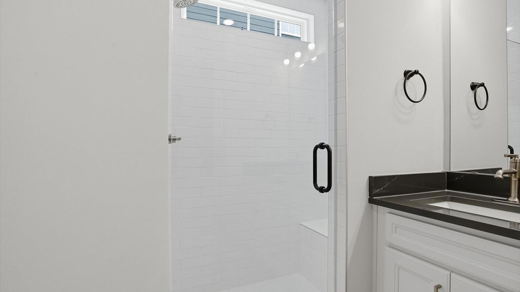 Superior en-suite primary bathroom with stylish walk-in shower—crafted with high standards in mind