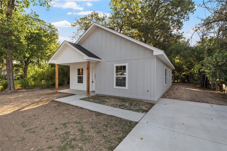 Modern inspired farmhouse with board and batten siding and covered porch
