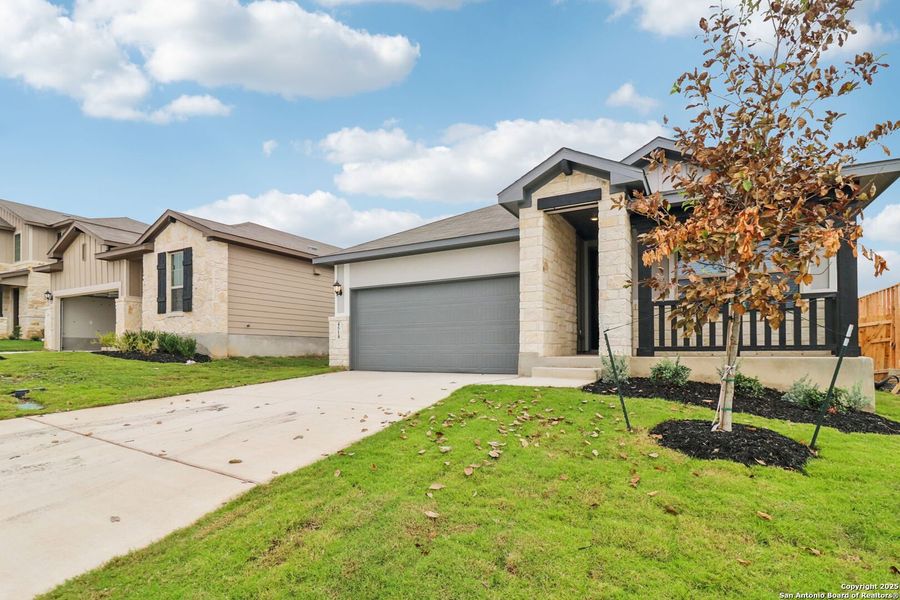 Front exterior of a new home in Remington Ranch, San Antonio, TX, highlighting curb appeal (Image 22). Front exterior of a new home in Remington Ranch, San Antonio, TX, highlighting curb appeal (Image 22).