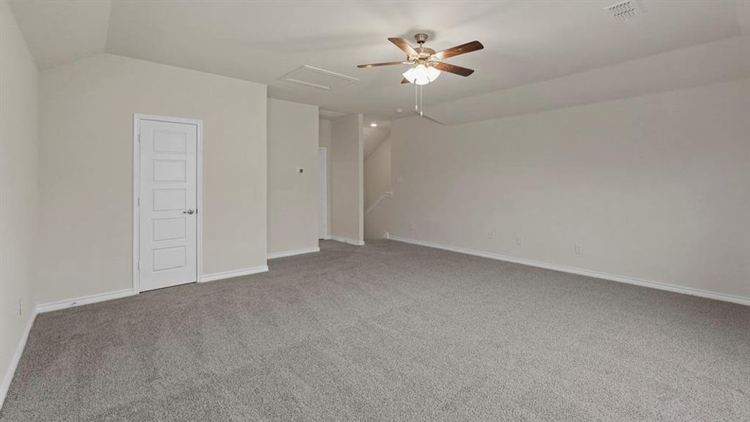 Spare room featuring light carpet, attic access, ceiling fan, and lofted ceiling Spare room featuring light carpet, attic access, ceiling fan, and lofted ceiling