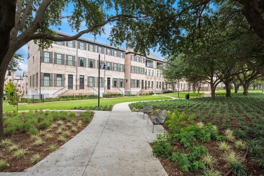 Townhome architecture featuring light-colored brick facades and dark window shutters