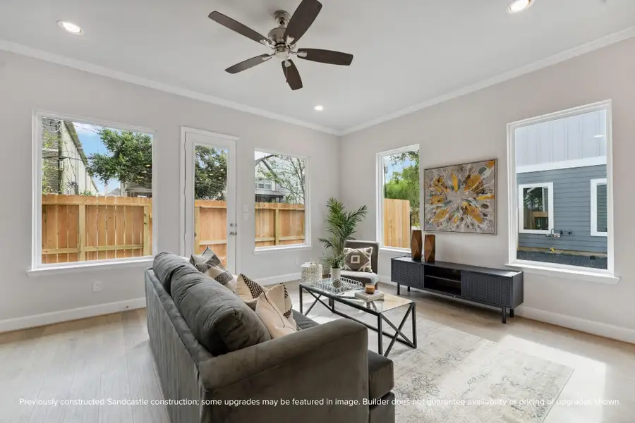 Living Room with Natural Light – Tall ceilings, recessed lighting, and oversized windows make this living space bright, airy, and perfect for relaxation.