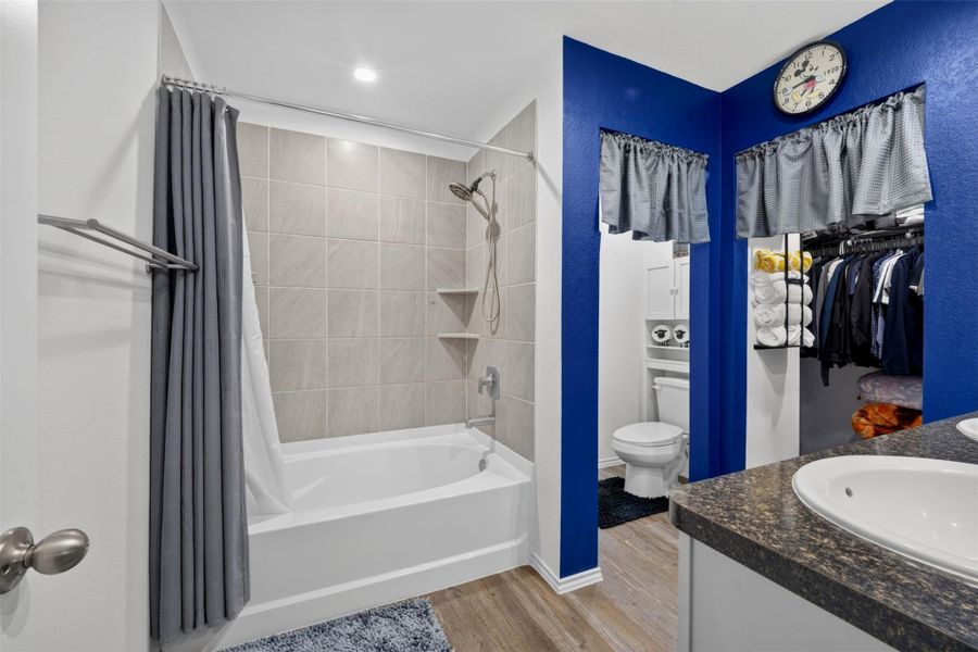 Primary bathroom features a tub and shower combination, vanity with storage and neutral finishes. Primary bathroom features a tub and shower combination, vanity with storage and neutral finishes.