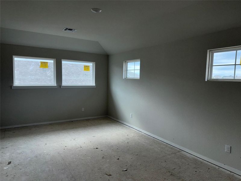 Spare room featuring lofted ceiling and baseboards Spare room featuring lofted ceiling and baseboards