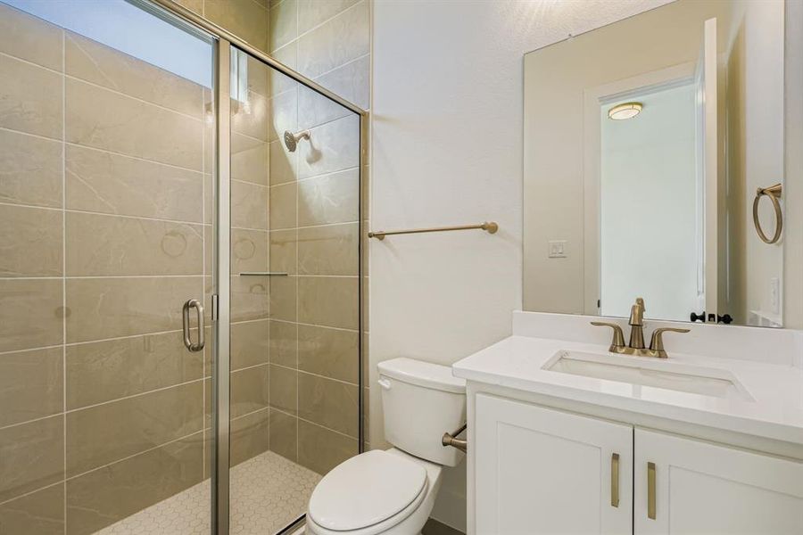 Bathroom featuring a shower stall and vanity
