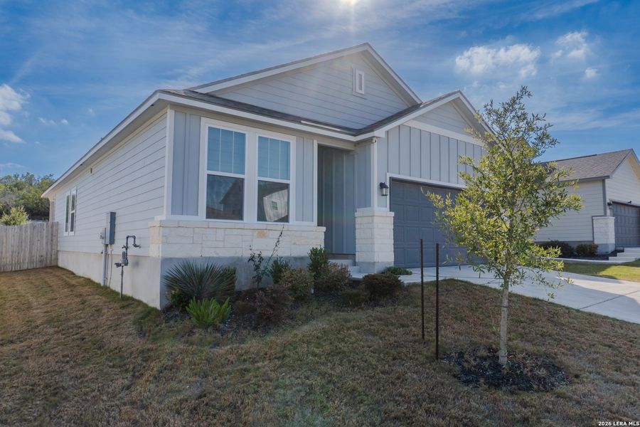 Front exterior of a new home in The Meadows at Hunters Ranch, San Antonio, TX, highlighting curb appeal (Image 2). Front exterior of a new home in The Meadows at Hunters Ranch, San Antonio, TX, highlighting curb appeal (Image 2).