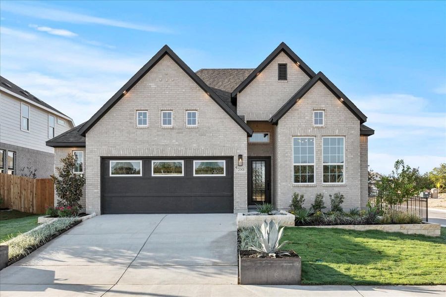 Front exterior of a new home in Stream Waters, Seguin, TX, highlighting curb appeal (Image 2).