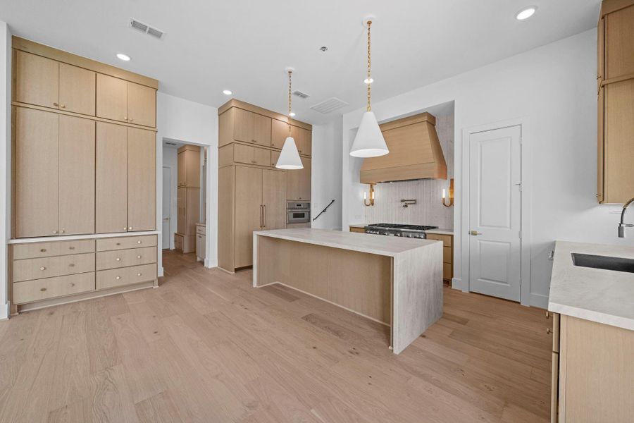 Chef-inspired kitchen with expansive island, generous cabinetry, and sophisticated finishes
