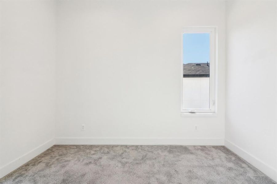 Empty room featuring light carpet