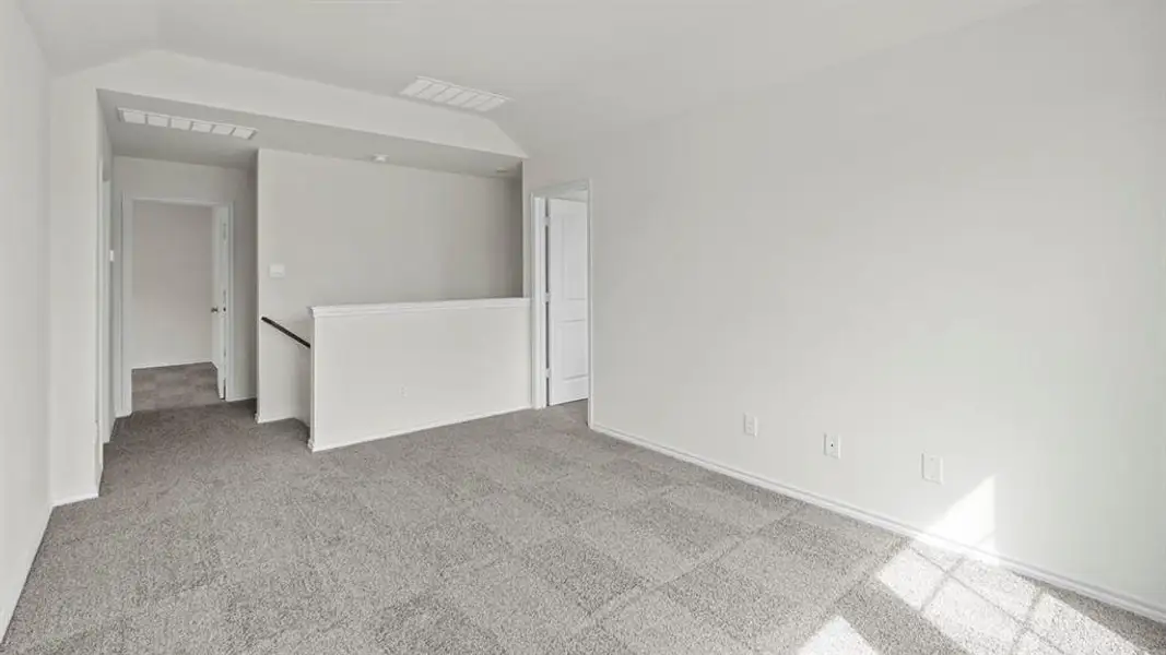 This versatile room features light gray carpeting and white walls, offering a neutral canvas for personalization