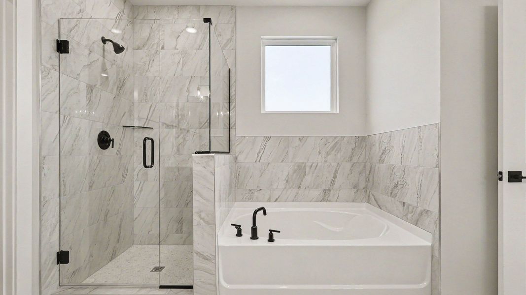 Tiled shower with glass door and seperate luxury tub