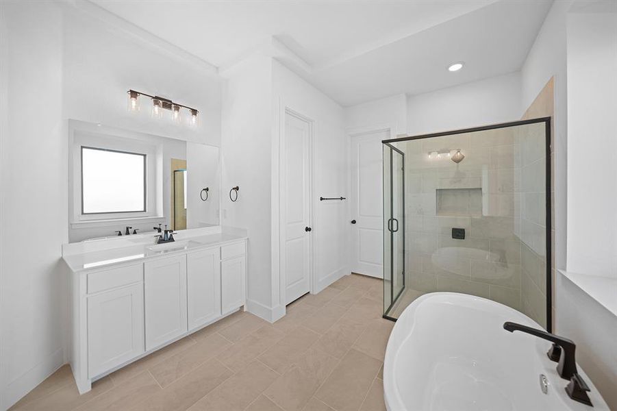 Full bathroom featuring a soaking tub, vanity, a shower stall, recessed lighting, and light tile patterned floors
