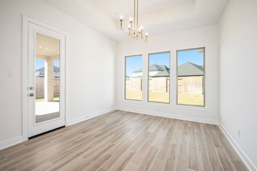 The home features a stylish casual dining area that perfectly blends comfort and elegance. Designed for everyday living and effortless entertaining, this inviting space offers beautiful natural light, open sightlines to the kitchen and family room, and high-end finishes that complement the home’s luxurious design.