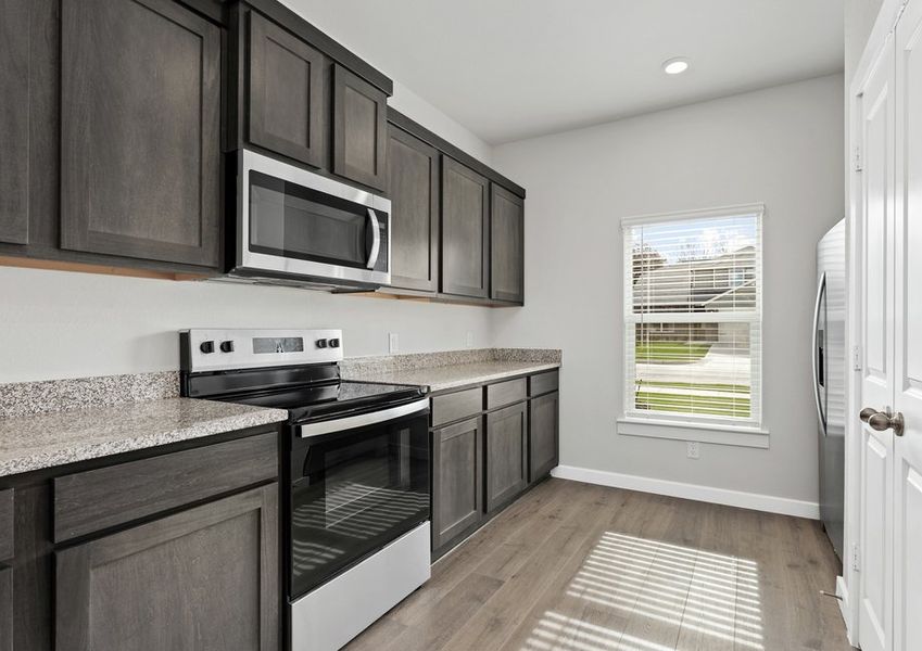 The kitchen has beautiful wood cabinetry.