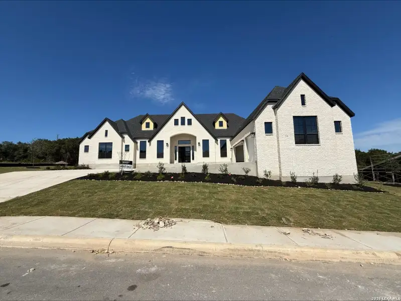 Front exterior of a new home in Caliza Reserve, Boerne, TX, highlighting curb appeal (Image 12).