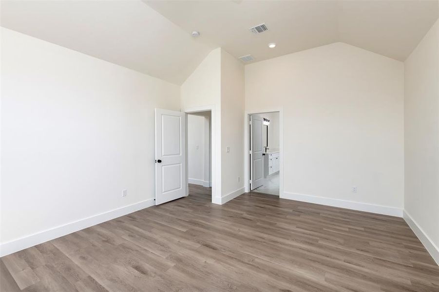 Unfurnished bedroom featuring baseboards, visible vents, and wood finished floors