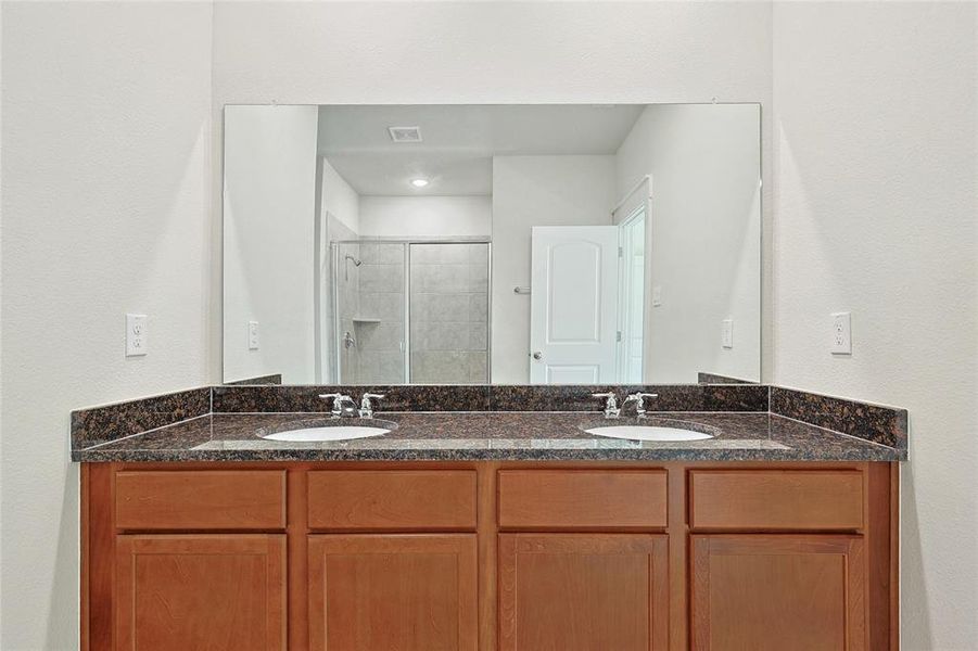 Bathroom featuring vanity and an enclosed shower