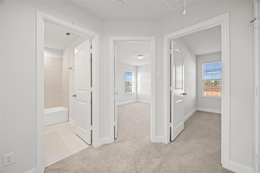 Upstairs hallway looking into the full bathroom and bedrooms 2 and 3