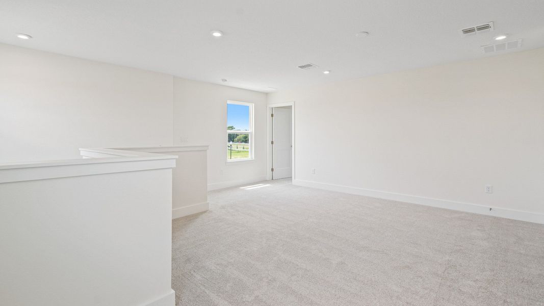 The Sweetgum Spacious and Bright second story loft area in Trailside at Mount Dora by DRB Homes