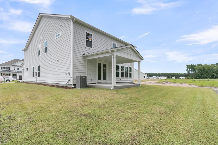 Front exterior of a new home in Tidewater at Lakes of Cane Bay, Summerville, SC, highlighting curb appeal (Image 2).