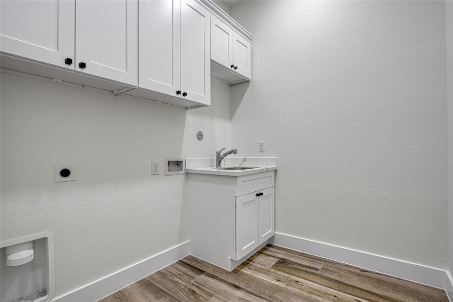 Large laundry room with plenty of cabinets and a sink! Large laundry room with plenty of cabinets and a sink!