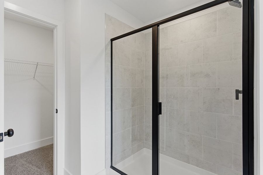 A shower with a glass door.
