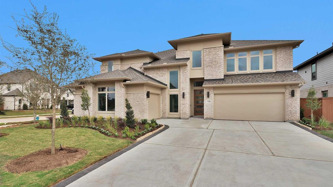 Front exterior of a new home in Elyson 65', Katy, TX, highlighting curb appeal (Image 1). Front exterior of a new home in Elyson 65', Katy, TX, highlighting curb appeal (Image 1).