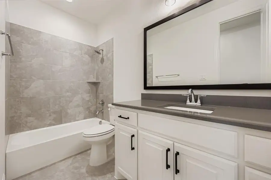 Full bathroom with tub / shower combination, vanity, and light tile patterned floors