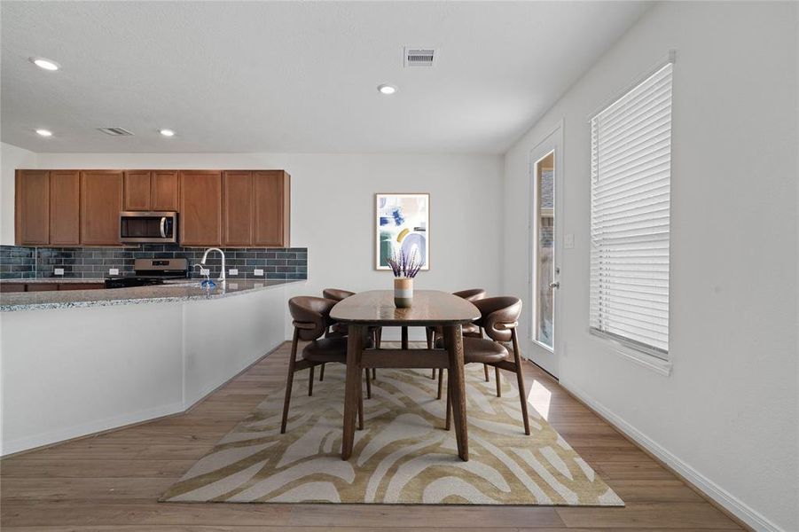 Start your day off right with a cup of coffee sitting with your family in the lovely breakfast area! Featuring large windows with blinds, custom paint and a large window with privacy blinds.