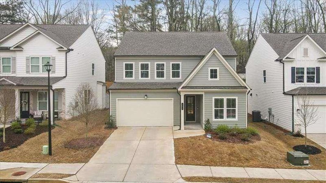 Front exterior of a new home in Enclave at Edgewater, Holly Springs, GA, highlighting curb appeal (Image 1). Front exterior of a new home in Enclave at Edgewater, Holly Springs, GA, highlighting curb appeal (Image 1).