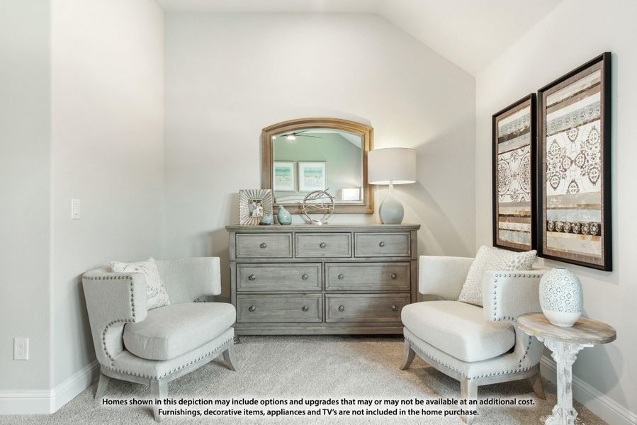 Bedroom sitting area with two upholstered chairs, gray dresser with mirror, and vaulted ceiling