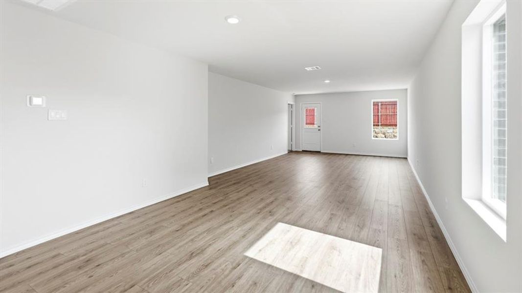 Empty room featuring light wood finished floors and recessed lighting Empty room featuring light wood finished floors and recessed lighting