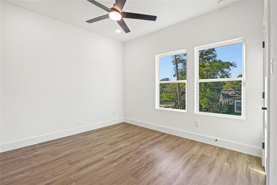 Unfurnished room featuring light wood finished floors, a ceiling fan, and recessed lighting