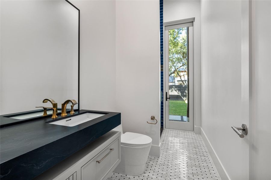Example of exceptional design in secondary baths. NOTE: This photo is a rendering of one of the builder’s prior homes and similarly used as an example for this home. Please contact the listing agent to tour this property and for more detailed information.