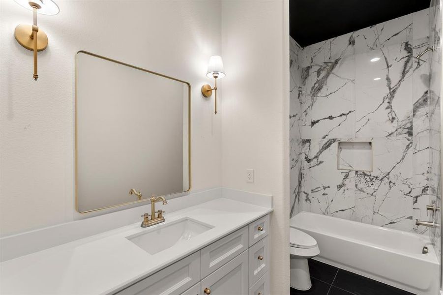 Full bath with vanity, shower / bath combination, and dark tile patterned flooring