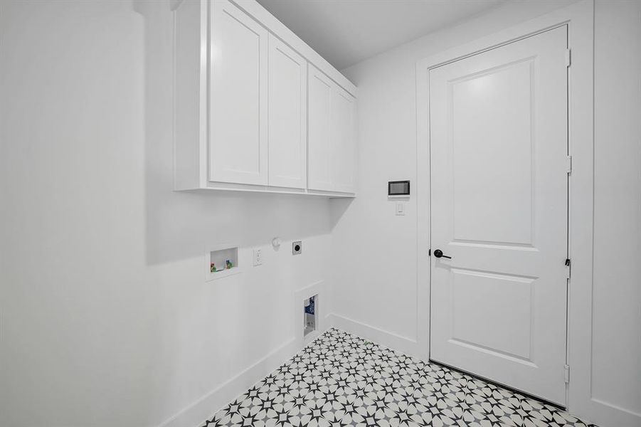 Laundry area with cabinet space, electric dryer hookup, gas dryer hookup, and hookup for a washing machine